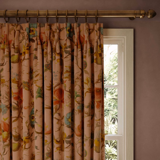 Blush velvet curtain with trailing botanical flowers in rust, ochre, green and teal
