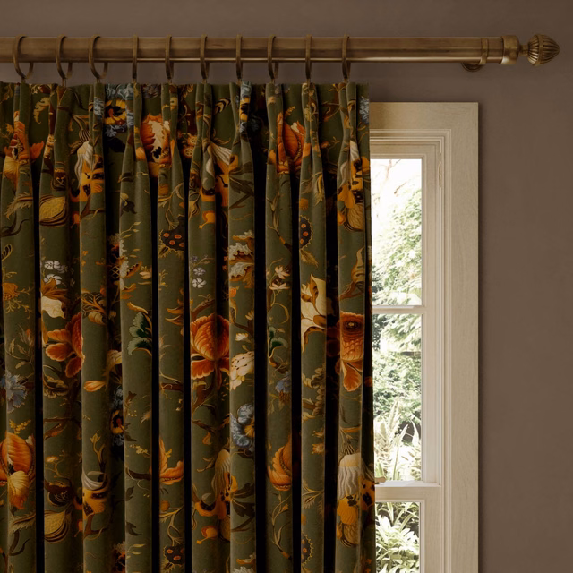 Moss-green velvet curtains with rust, ochre and cream botanical motifs