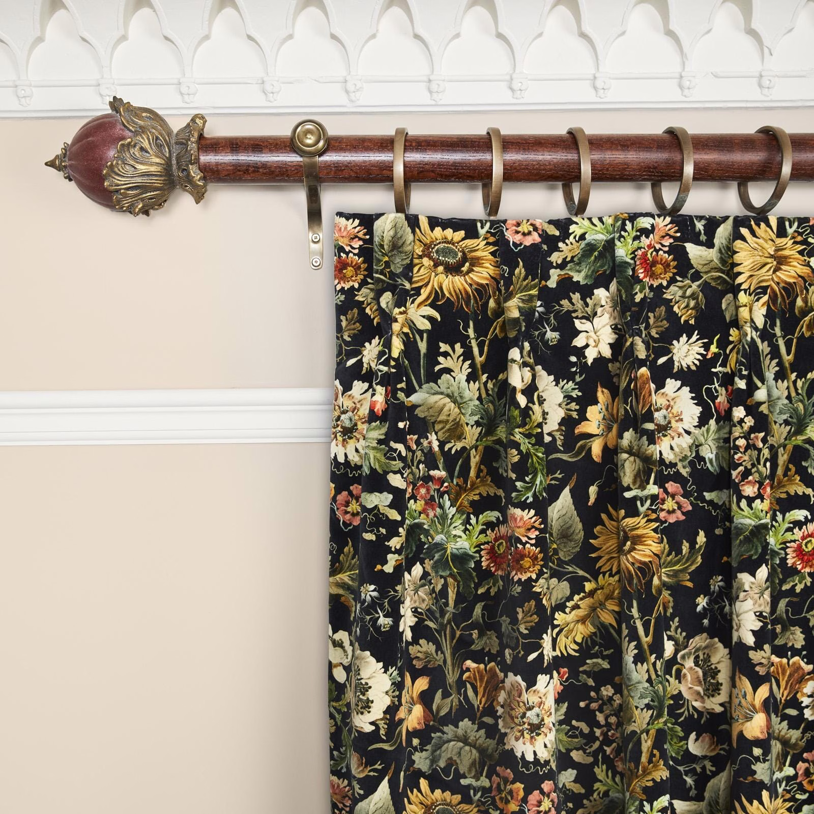Near-black velvet curtain with dense gold, cream and green botanical flowers