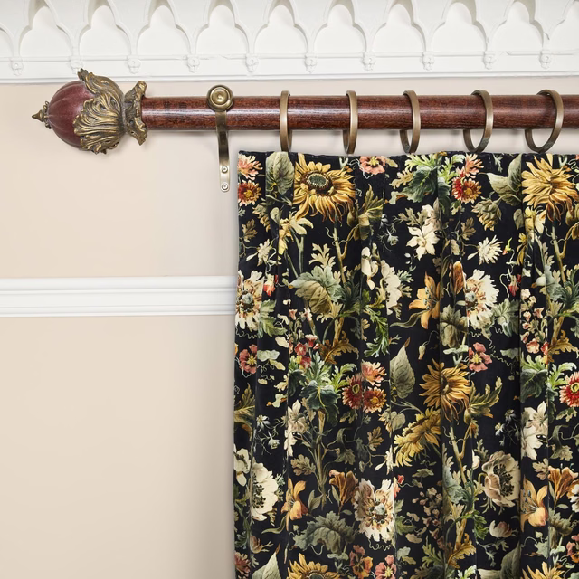 Near-black velvet curtain with dense gold, cream and green botanical flowers