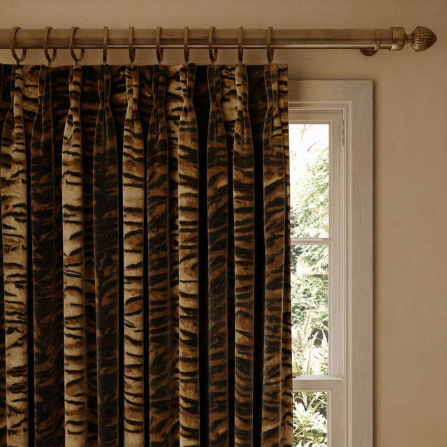Cocoa velvet curtain with bold tiger-like brown and black stripes in deep pleats