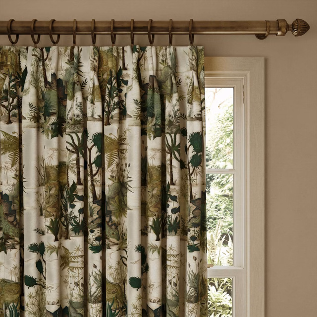 Warm ecru curtain with dense olive botanical foliage and dark brown stems