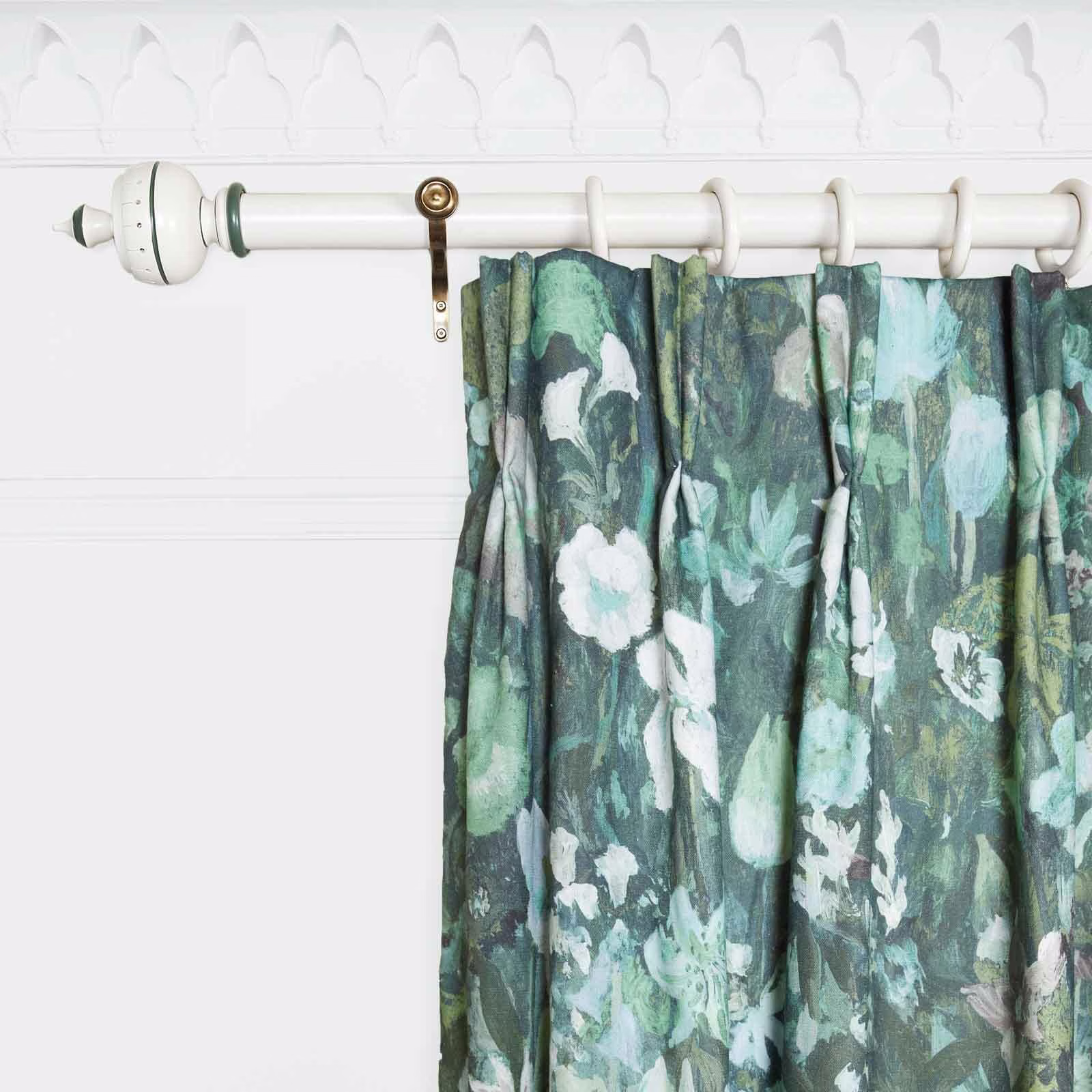 Deep teal curtain with painterly white blooms, sage leaves and fluid pleats