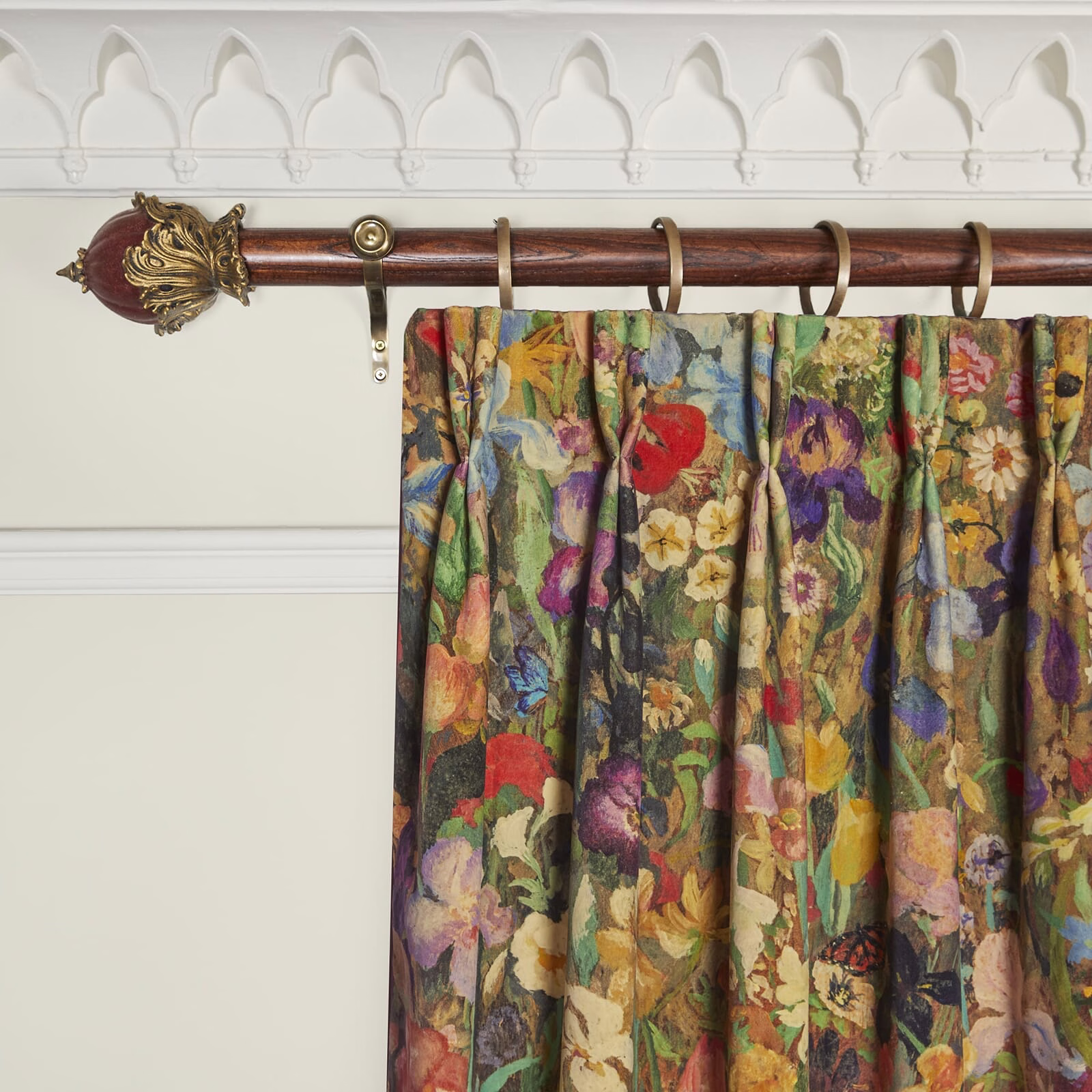 Deep floral velvet curtain with red blooms, plum shadows and gathered folds