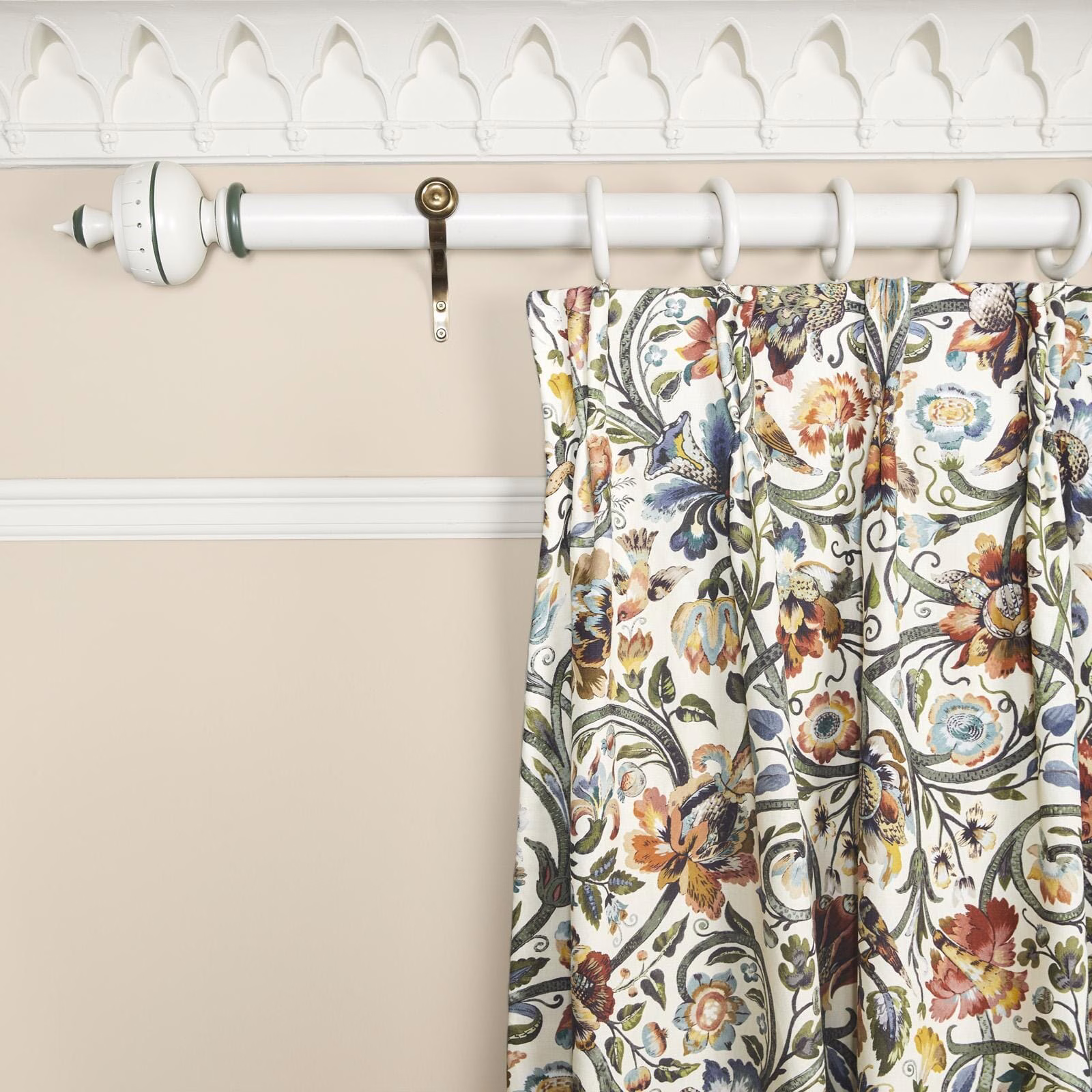 Warm ecru curtain with curling botanical stems and multicoloured painterly flowers