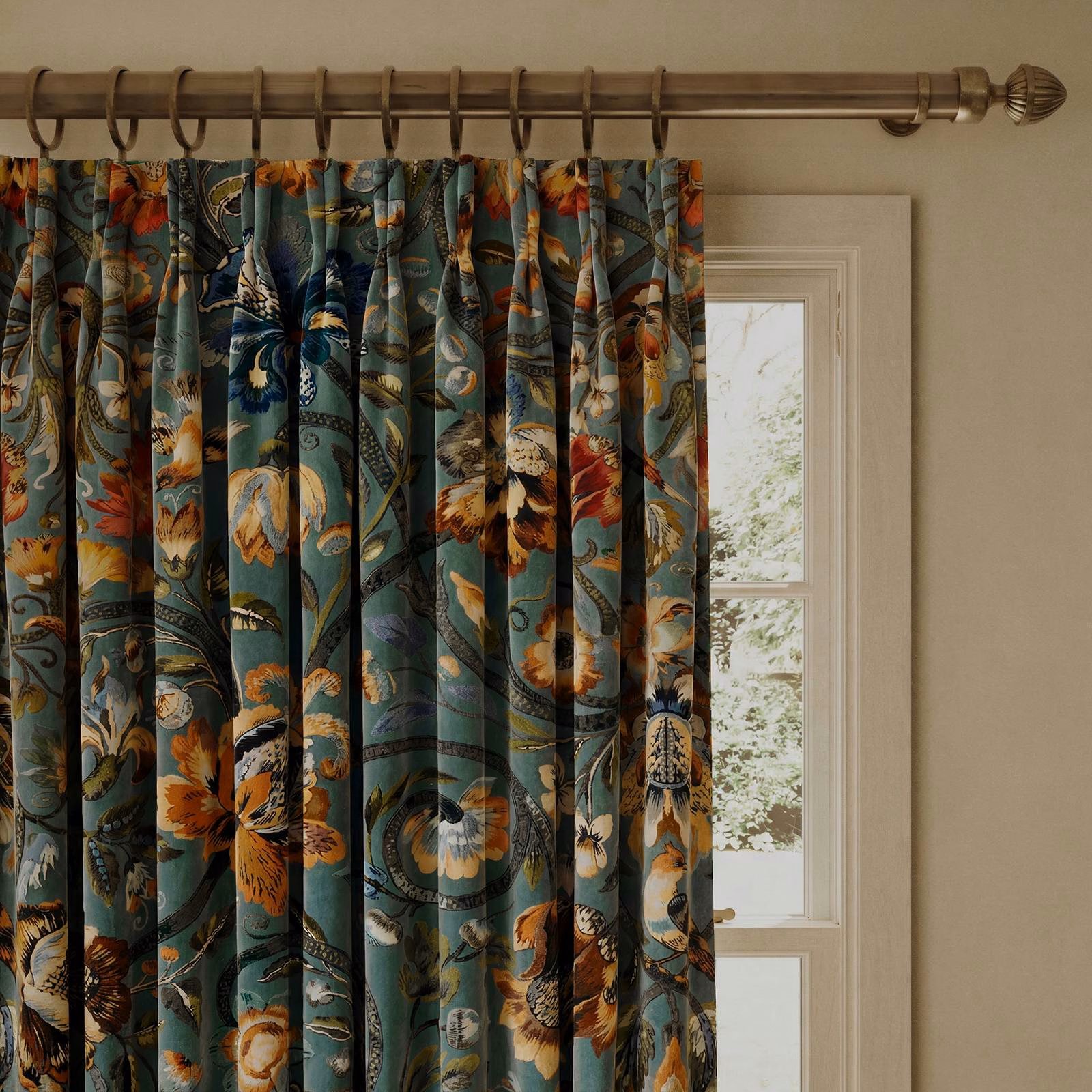 Prussian blue velvet curtain with teal folds and ochre botanical blooms