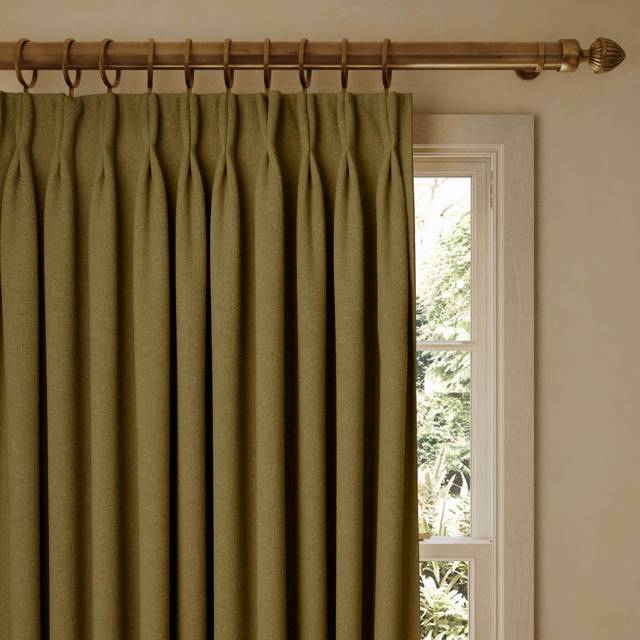 Muted olive-green curtain with fine woven texture and deep vertical folds
