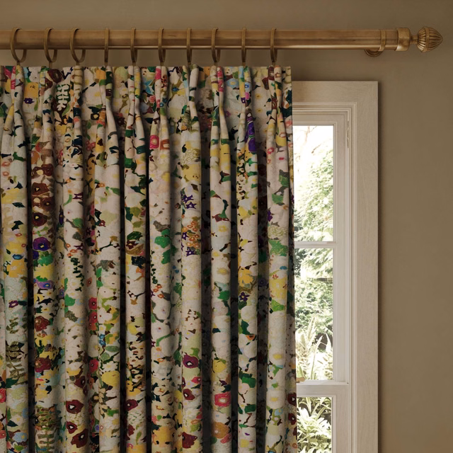 Warm cream curtain with scattered jewel-toned flowers and leafy botanical marks