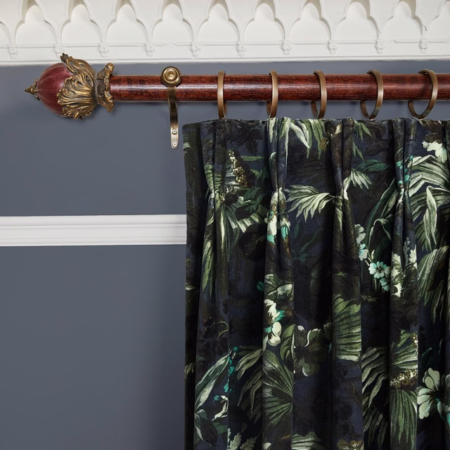 Gathered ink velvet curtain with sage tropical leaves and teal floral accents