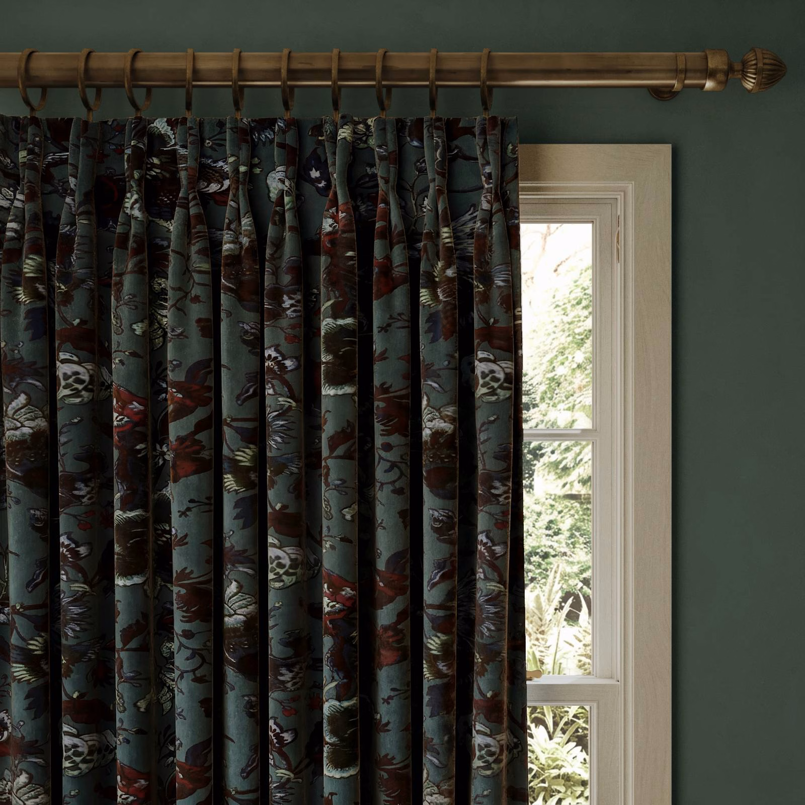 Petrol velvet curtain with dark botanical motifs and muted red, cream and olive accents