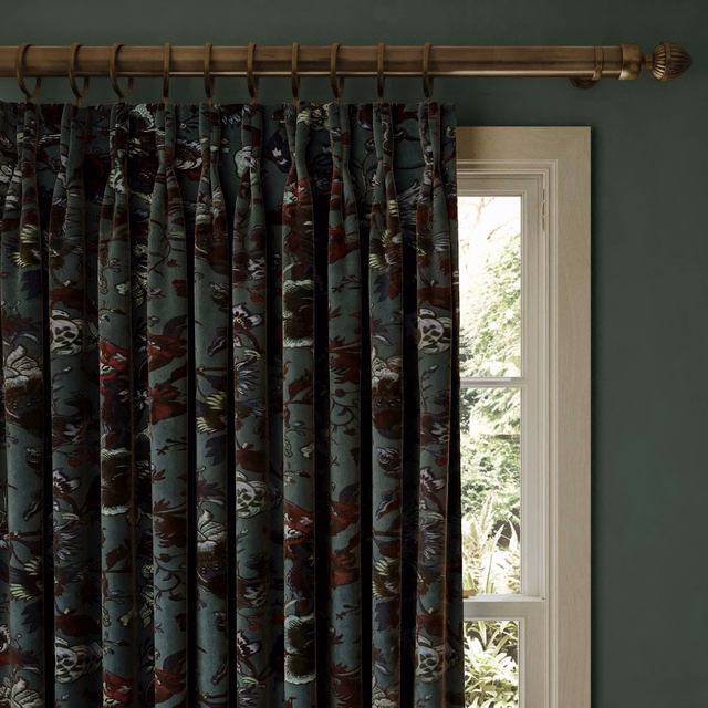 Petrol velvet curtain with dark botanical motifs and muted red, cream and olive accents
