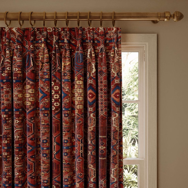 Deep sienna velvet curtain with navy, cream and antique-gold geometric motifs