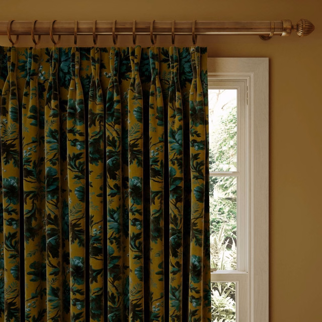 Bronze velvet curtain with teal and deep green botanical foliage in vertical pleats