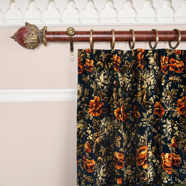 Midnight velvet curtain with orange flowers and muted gold foliage in deep pleats