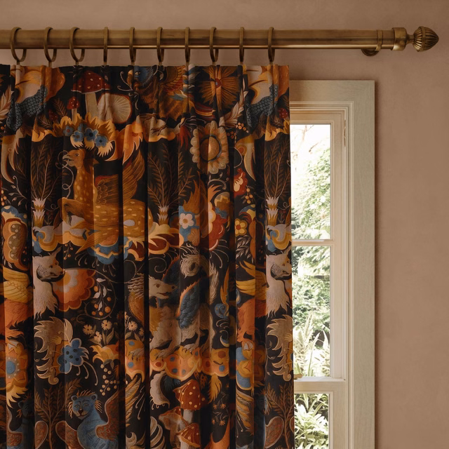 Selenite Orange velvet curtain with burnt-orange florals, blue flowers and dark botanical ground