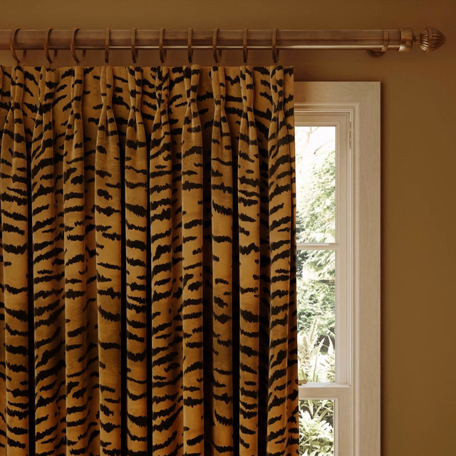 Warm taupe velvet curtain with irregular black tiger stripes in deep pleats
