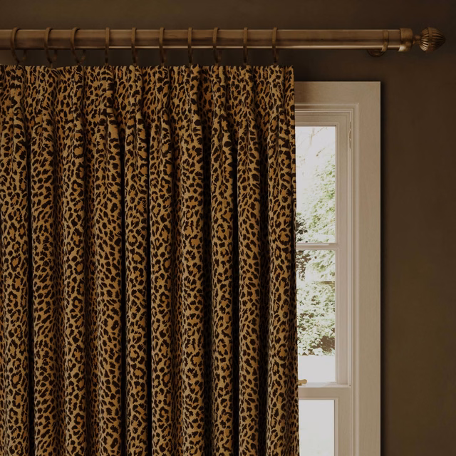 Butterscotch jacquard curtain with black leopard spots and softly ridged folds