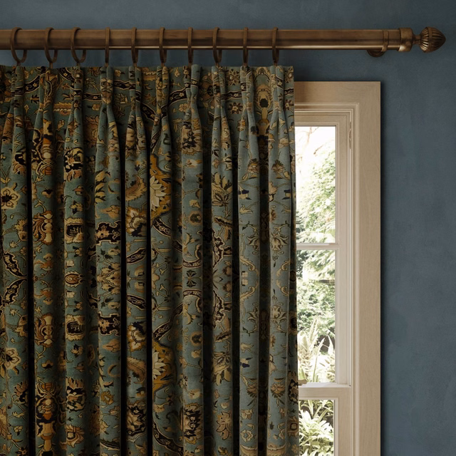 Deep sapphire velvet curtains with gold, olive and rust botanical motifs
