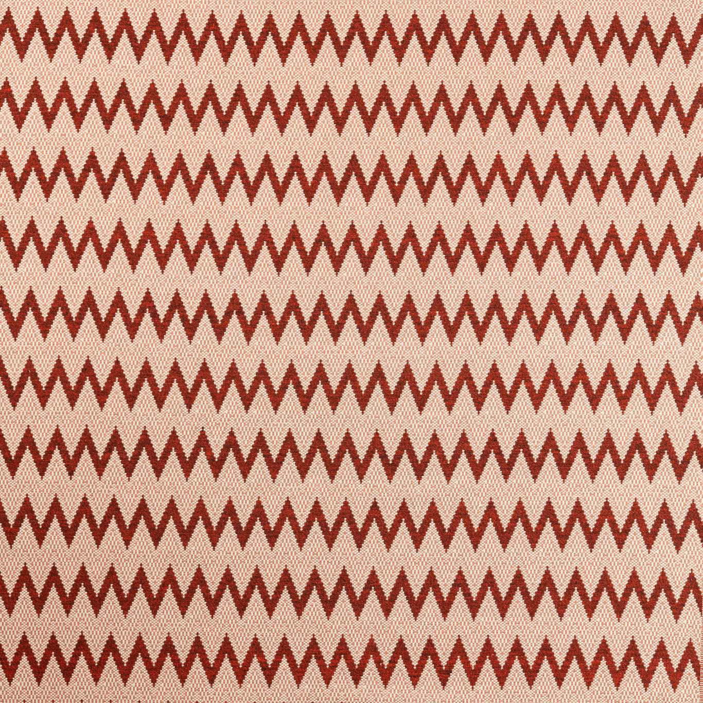 Deep brick-red zigzags repeat across a warm cream, textured woven ground
