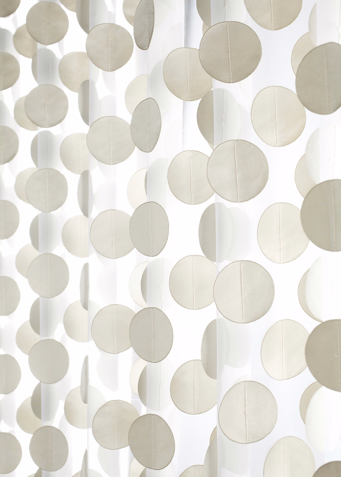 Pale champagne textile with translucent vertical bands and overlapping circular motifs