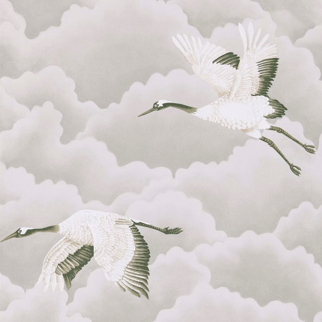 White cranes in flight over platinum-grey cloud forms with muted green wing details