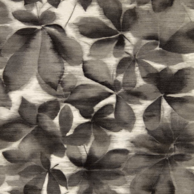 Black earth botanical leaves layered over parchment with fine horizontal surface striations