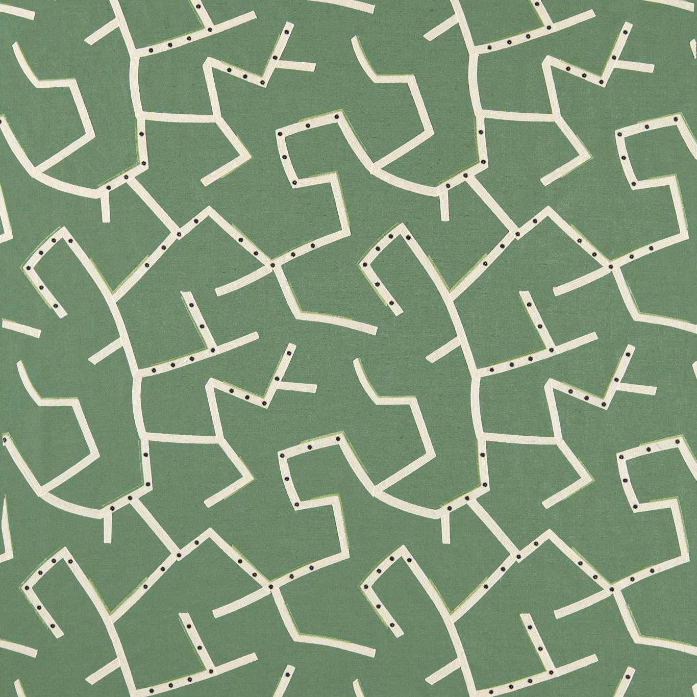 Muted jade-green textile with cream angular pathways and dark dotted accents