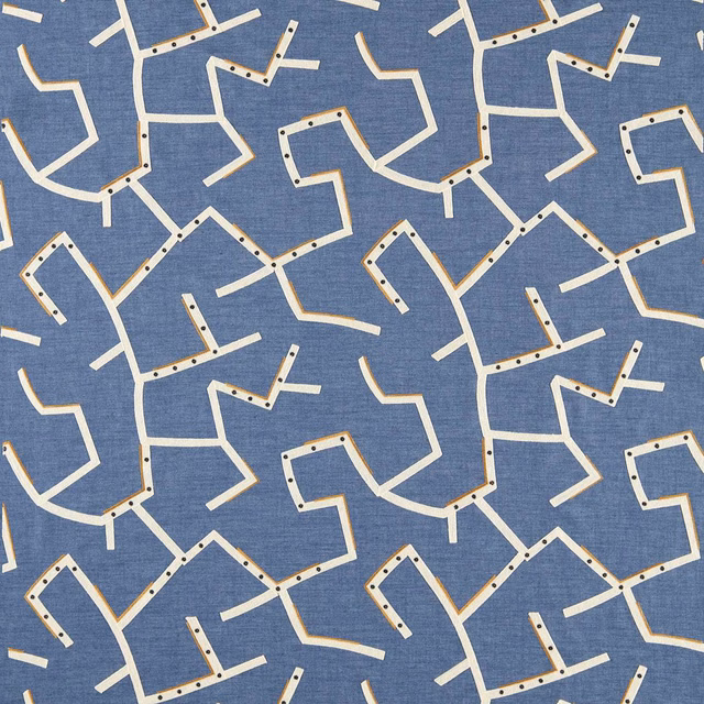 Cool denim-blue woven fabric with cream angular lines and dark dotted accents