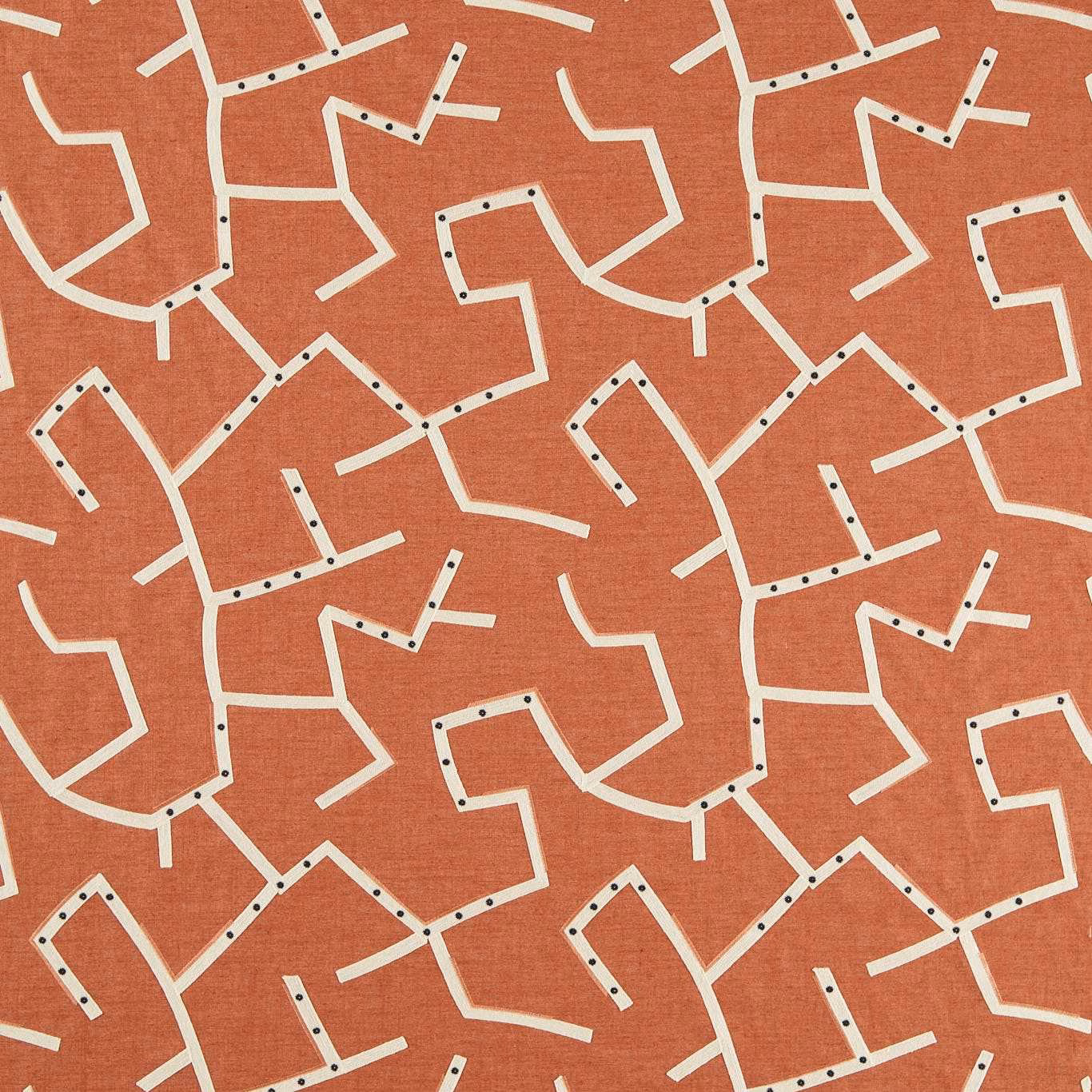 Warm rust woven ground with cream angular lines and dark dot accents