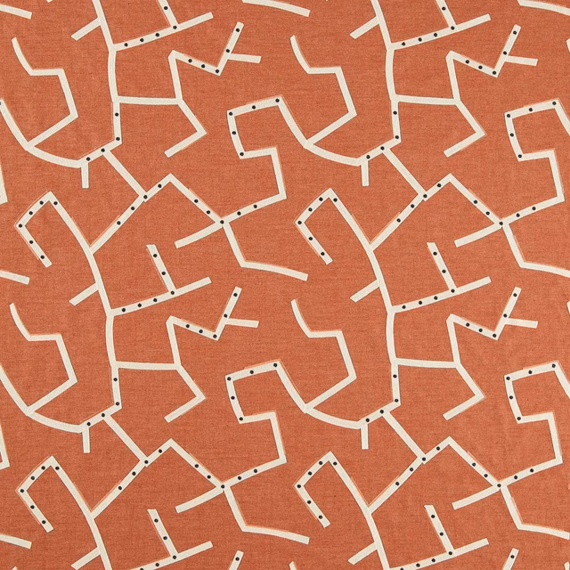Warm rust woven ground with cream angular lines and dark dot accents