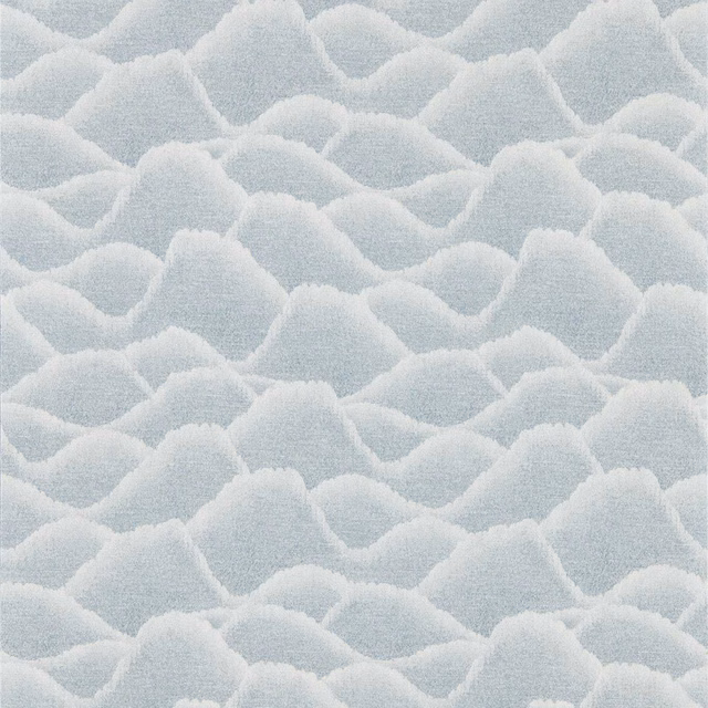 Pale blue-grey wallpaper with overlapping soft-edged cloud forms and fine grain