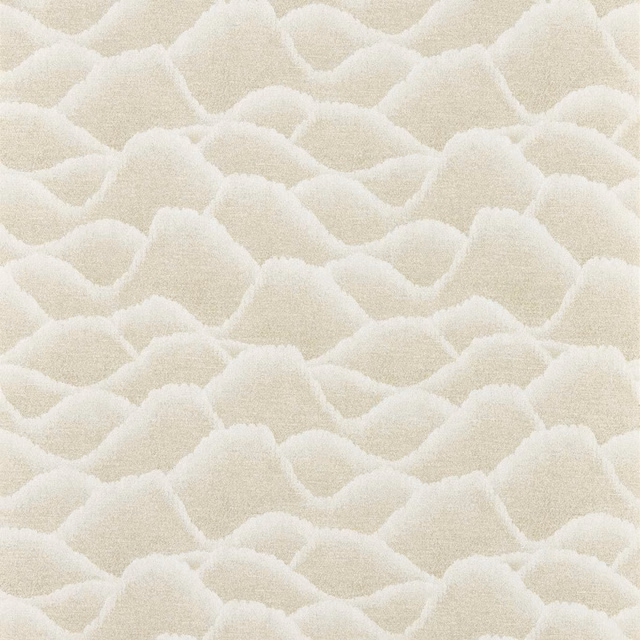 Warm cream wallpaper with raised, overlapping pebble-like forms and soft pumice shading