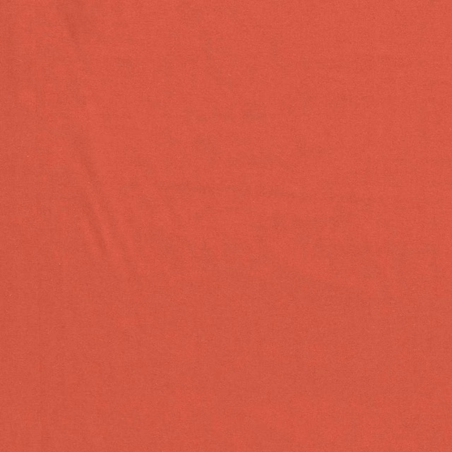 Muted coral plain textile with a fine, subtly textured woven surface