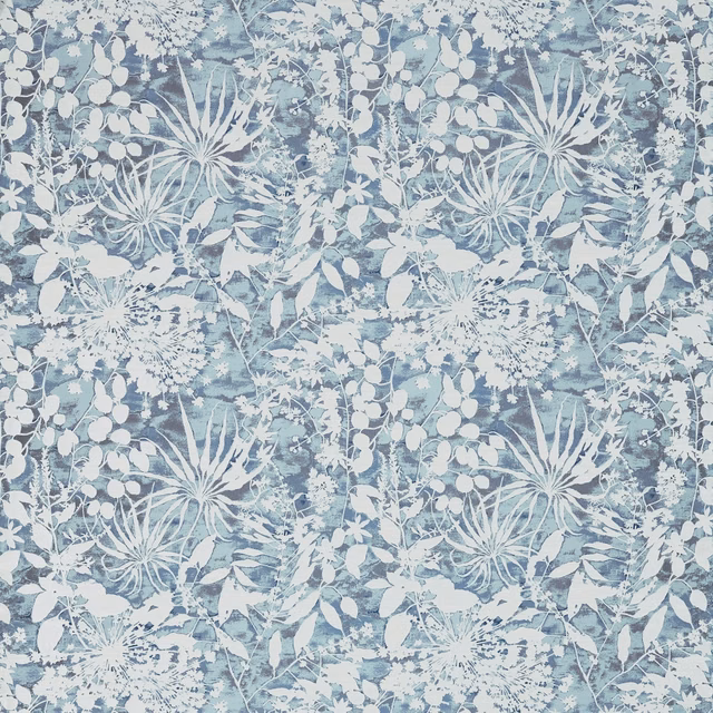 Cool blue-grey botanical fabric with chalk-white leaves and radial seedheads