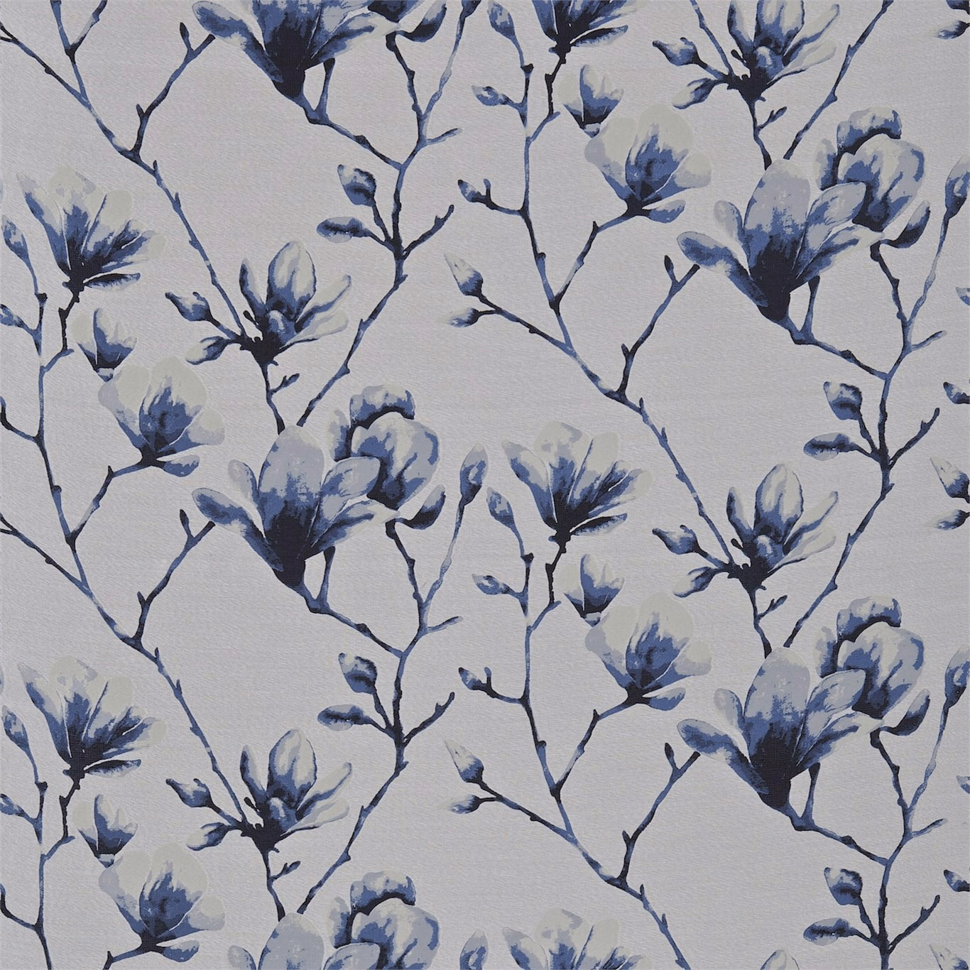 Indigo and pale blue flowering branches on a finely textured silver-grey fabric