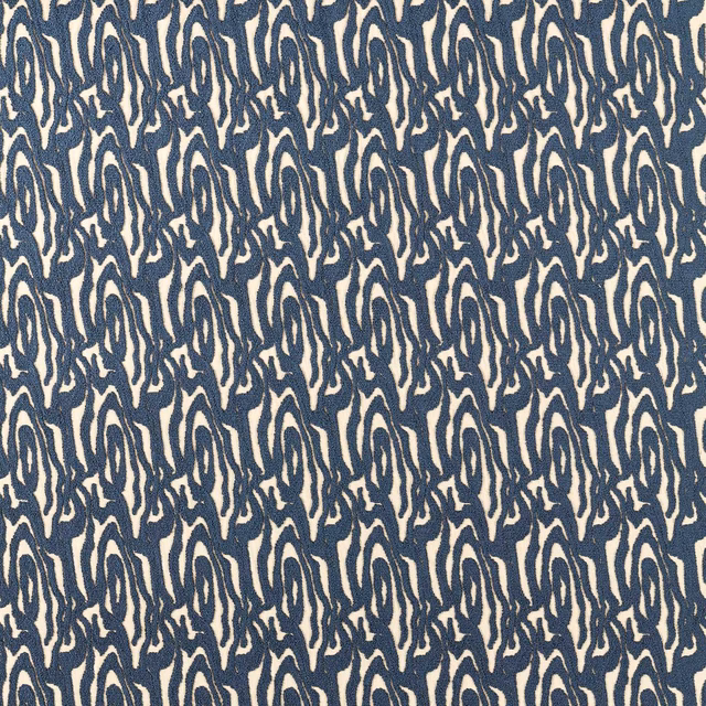 Ink-blue and ivory abstract wave motifs in a dense woven upholstery fabric