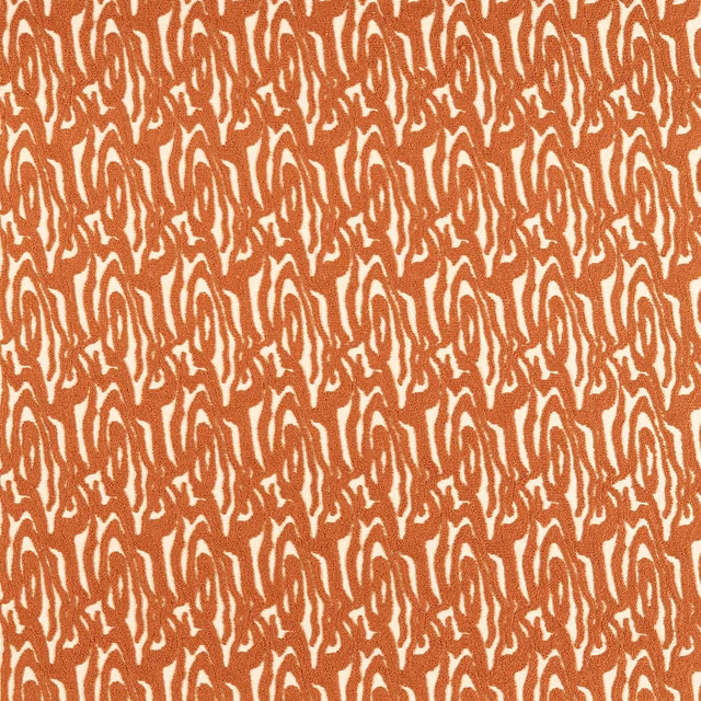 Rust terracotta looping strokes densely woven across a warm cream fabric ground