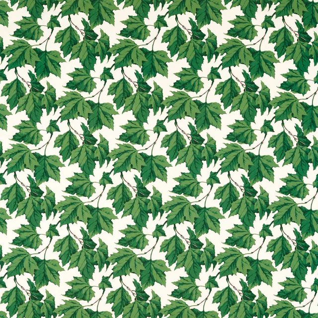 Emerald leafy branches with dark veins repeat across an ivory fabric ground