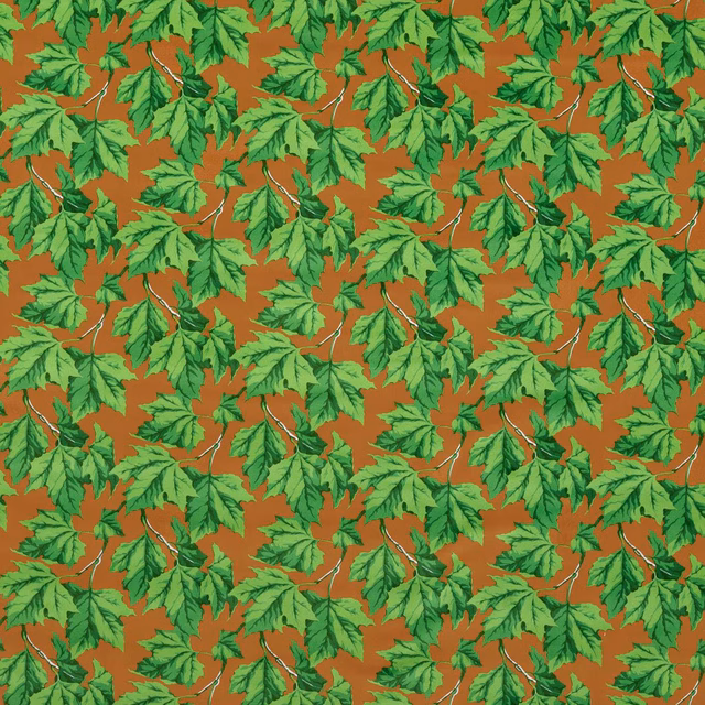 Emerald leafy sprigs with pale stems over a warm rust-amber velvet ground