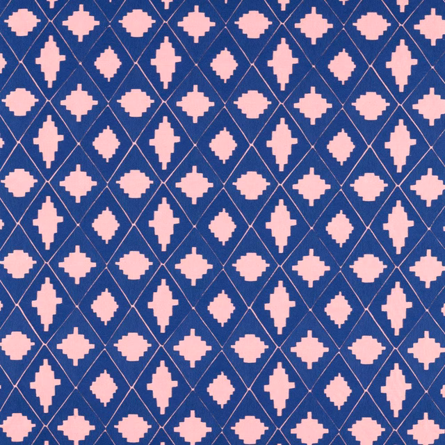 Deep lapis blue fabric with rose stepped motifs and a fine diagonal lattice