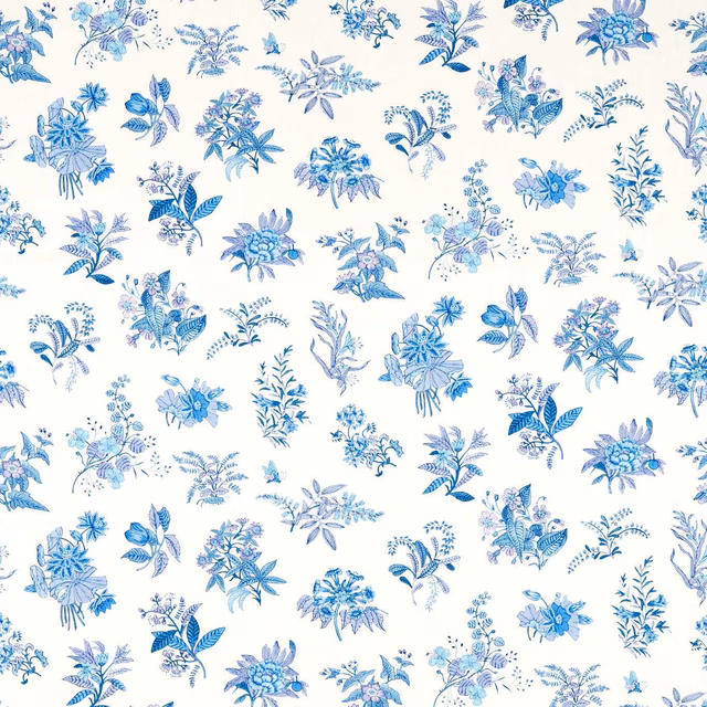 Blue and lavender botanical bouquets scattered across a pearl-white fabric ground