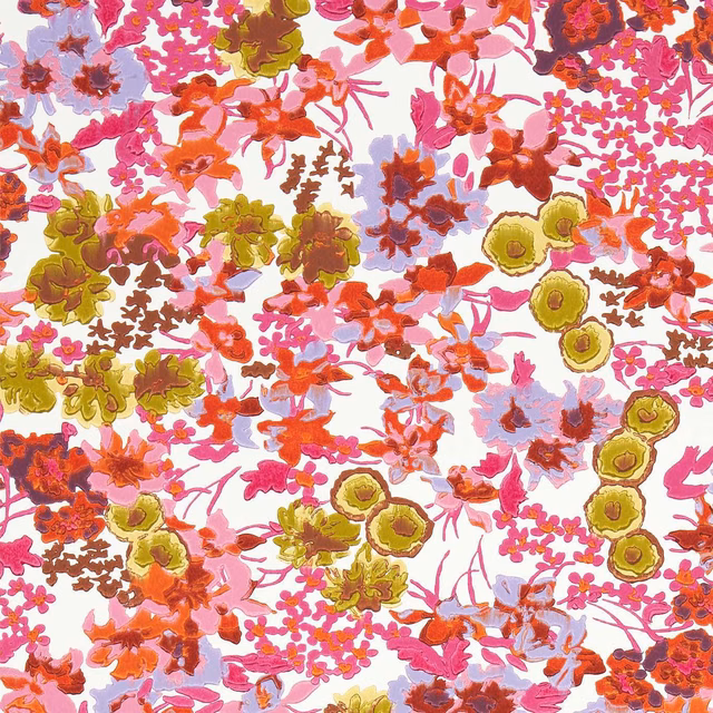 Dense coral, pink, olive and lilac wildflowers scattered across a pale wallpaper ground