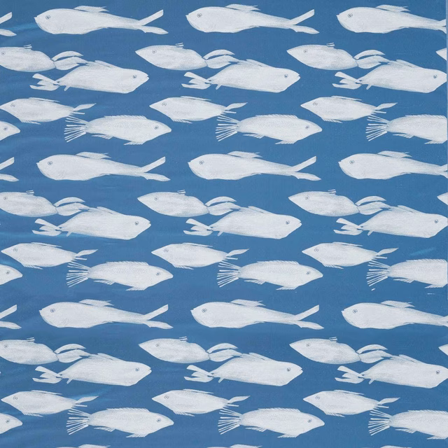 Cool denim-blue fabric with rows of chalk-white fish motifs