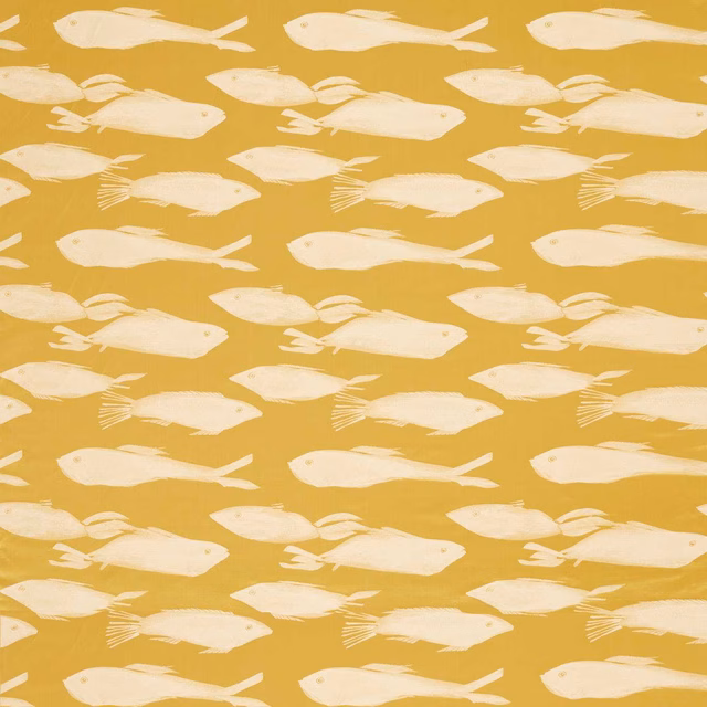 Cream fish silhouettes drifting across a warm honey ochre fabric ground