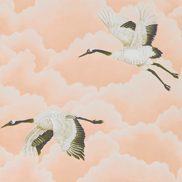 Blush pink wallpaper with white cranes, dark wing markings and peach cloud forms