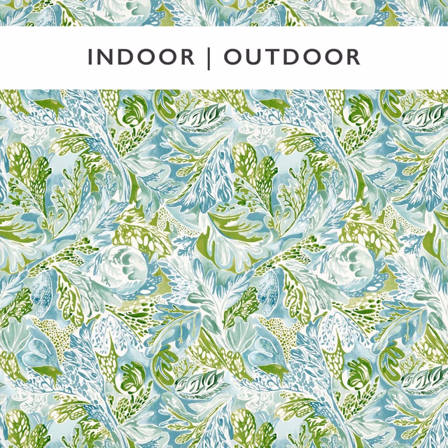 Pale sky-blue botanical fabric with pea-green leaves, white blooms and stone-grey accents