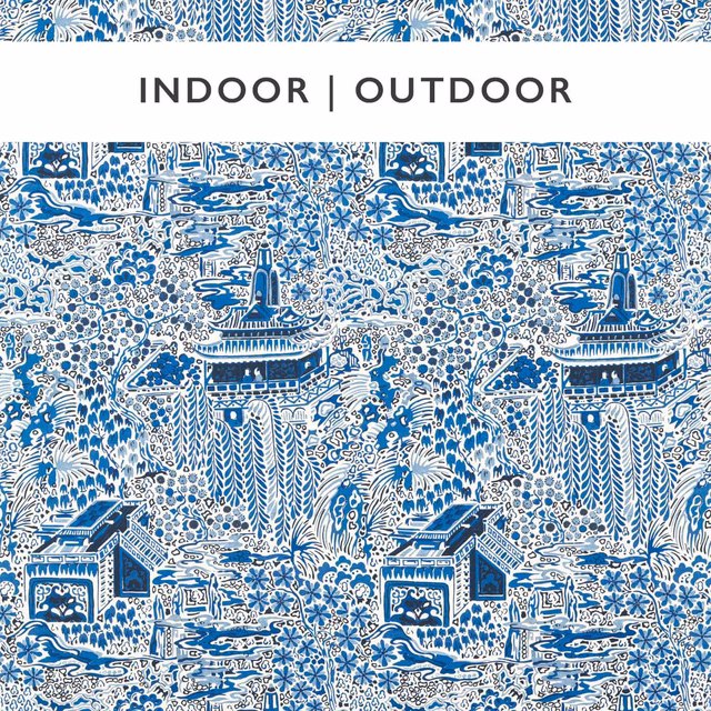 Ink-blue pagodas, houses and foliage repeat across an ivory printed fabric ground