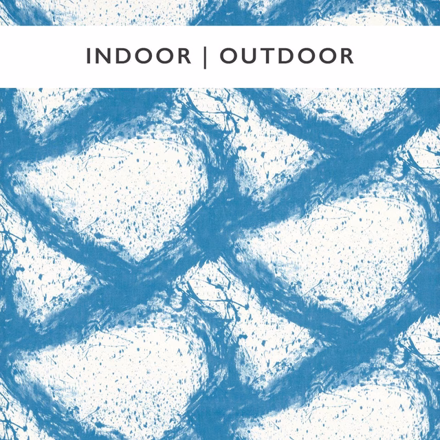 Chalky blue brushstrokes form irregular ivory shapes on a speckled outdoor fabric