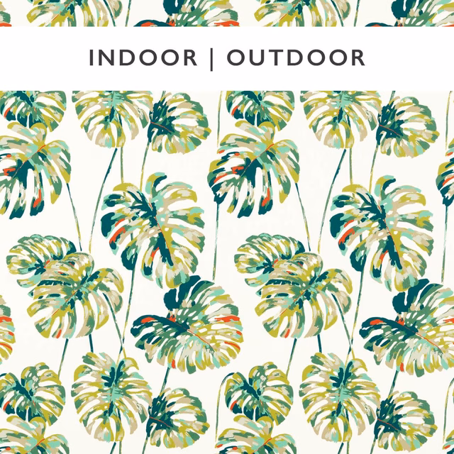 Emerald, olive and ochre tropical leaves scattered across a warm ivory ground