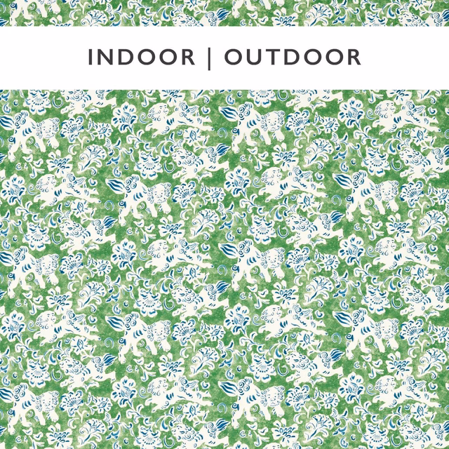 Dense white floral scrolls with indigo accents on a leafy Kelly-green ground